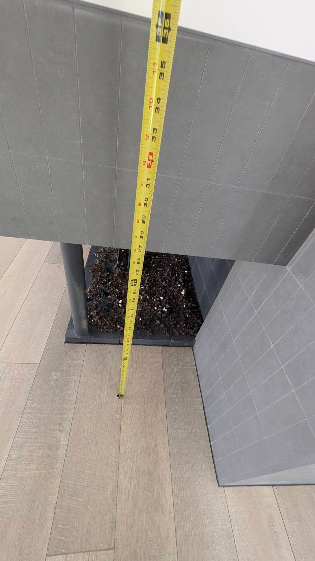 Corner fireplace opening measured with a tape measure before ordering